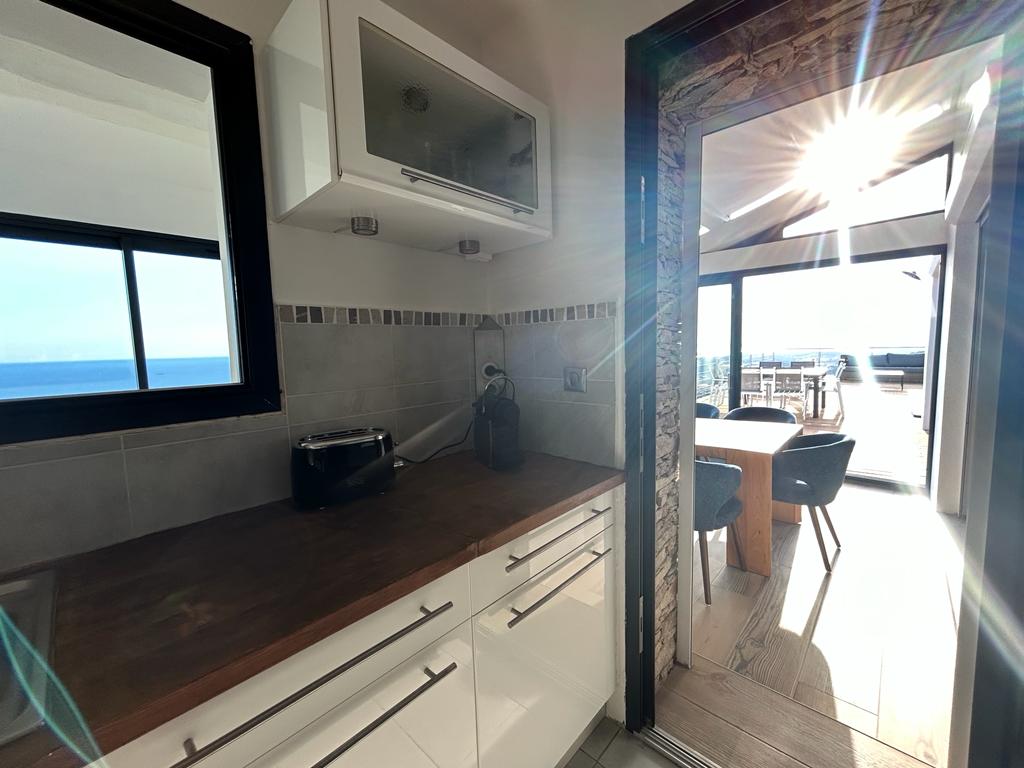 Kitchen of the villa with 180° sea view facing the golden islands